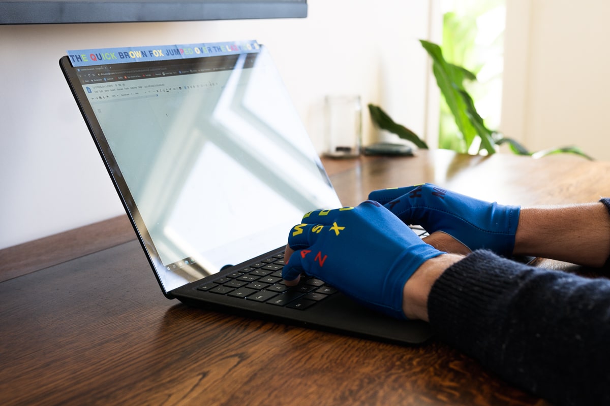 typing on laptop with mojogloves on
